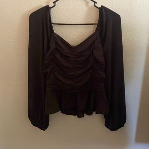 Cute black top with ruffles in the front!